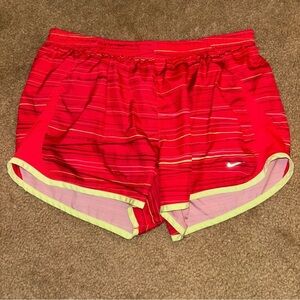 NIKE pink shorts with yellow trim, elastic waist, size medium